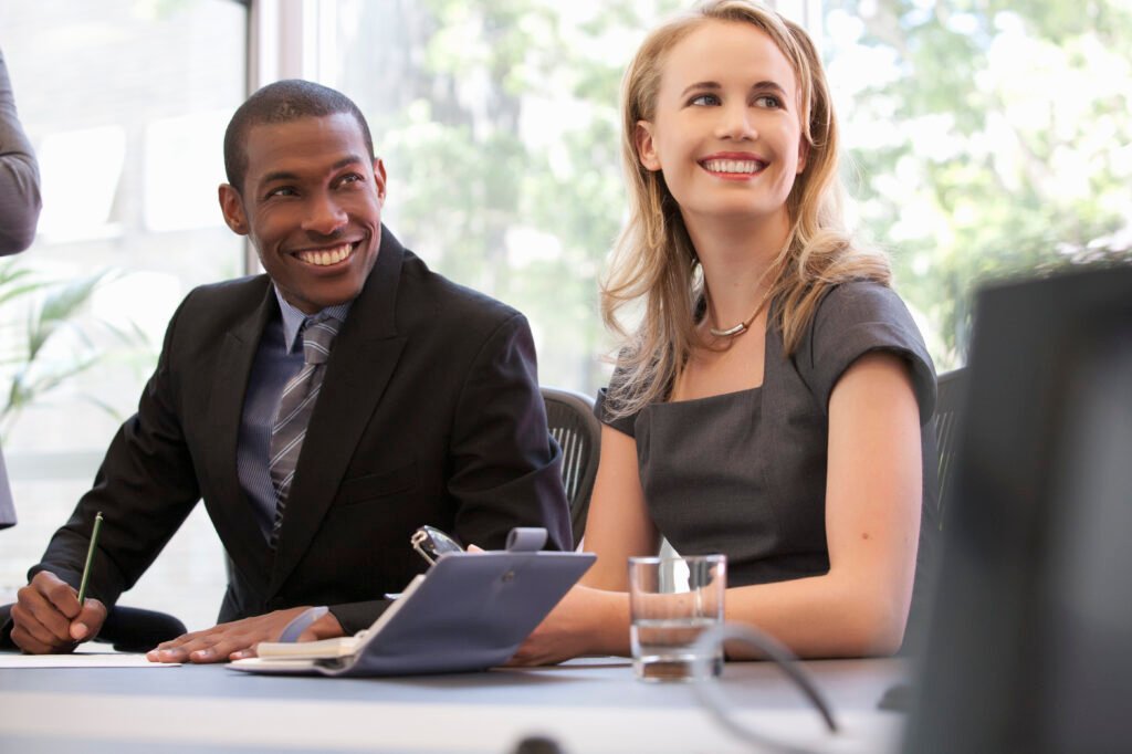 Business colleagues smiling at meeting
